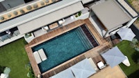 an aerial view of a house with a swimming pool